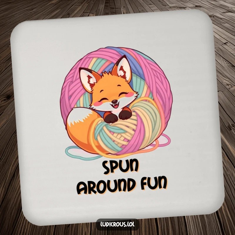 Funny giggling fox tangled in a ball of yarn on a drink coaster, adding playful and humorous protection to surfaces.