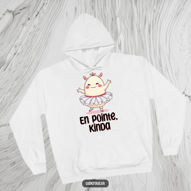 Funny hoodie design of a smiling blob monster adorned in a ballet tutu, attempting a graceful yet wobbly ballet pose.
