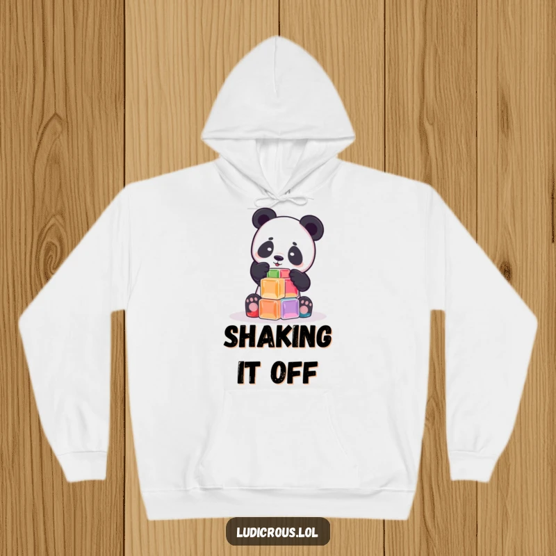 Funny playful panda attempting to build a tower out of wobbly Jell-O cubes on a hoodie, embodying wobbly fun and coziness.