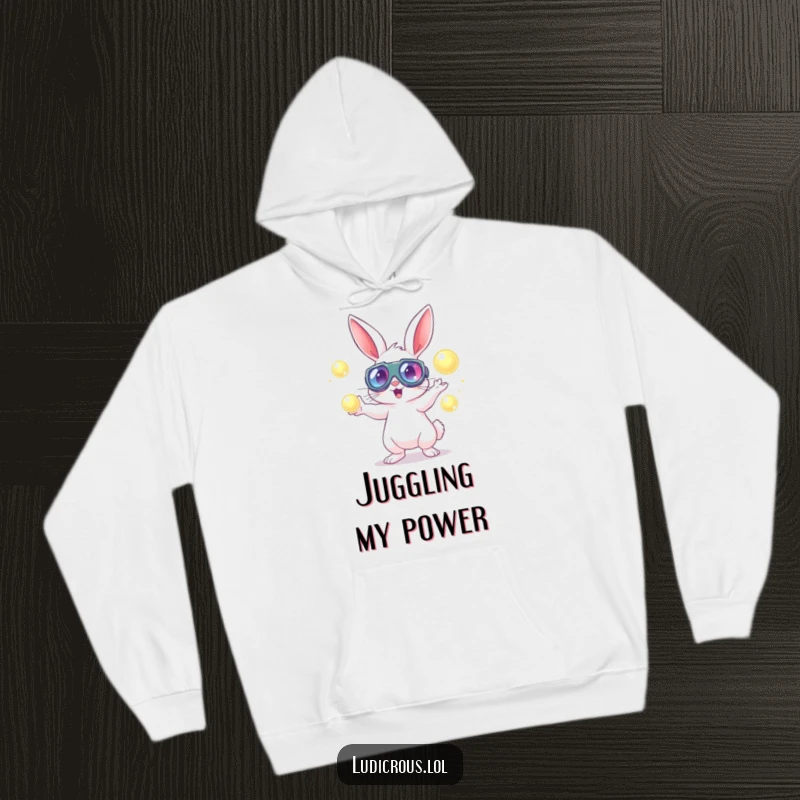Cozy hoodie featuring a rabbit in oversized goggles energetically juggling glowing orbs, perfect for sci-fi fans.