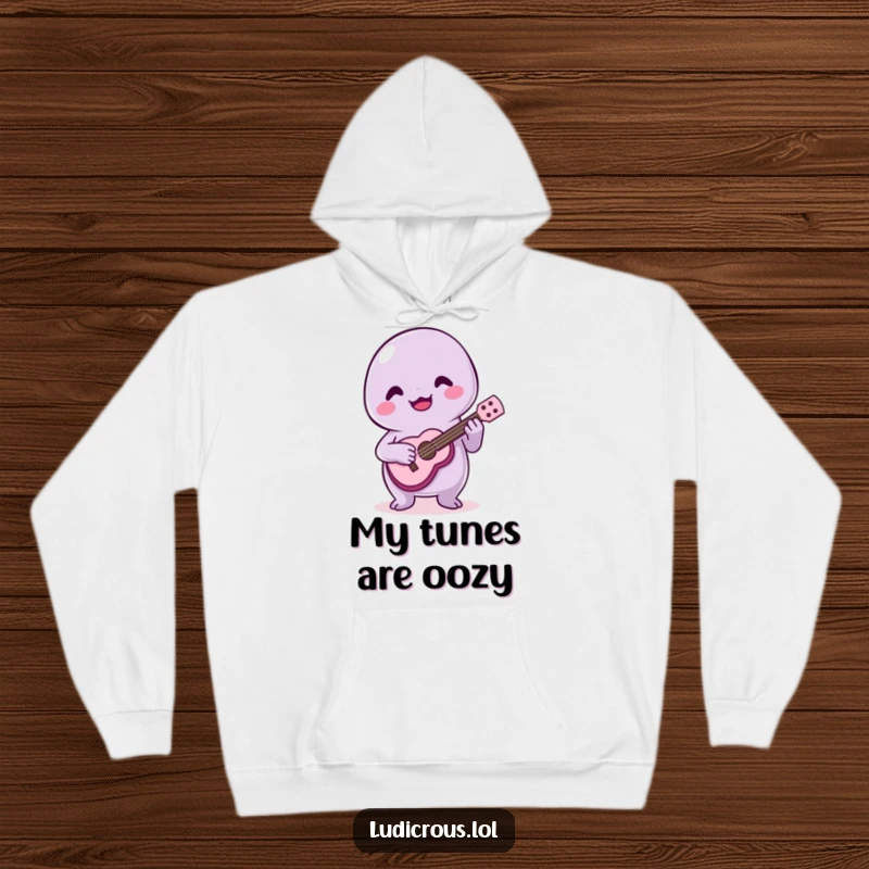 Funny hoodie featuring a grinning slime creature strumming a small ukulele with a comical, off-key musical effort.