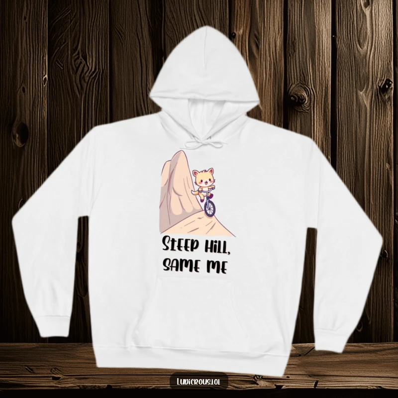Funny hoodie showing a playful critter comically riding a unicycle down a ridiculously steep hill, designed for cozy adventure.