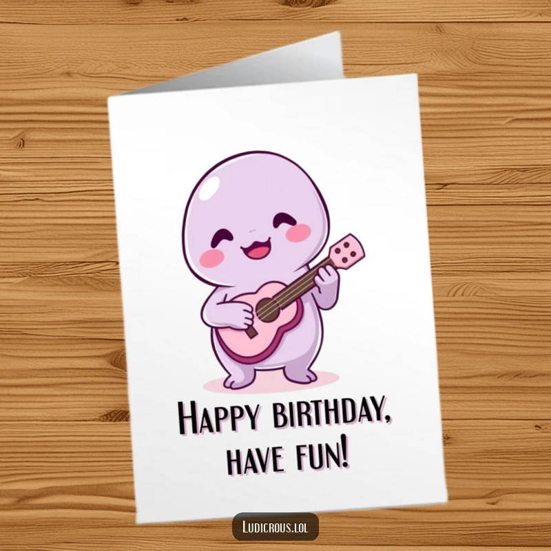 Funny Free Printable Birthday Card: A joyful slime creature plays a tiny ukulele with questionable skill. A musical birthday wish.