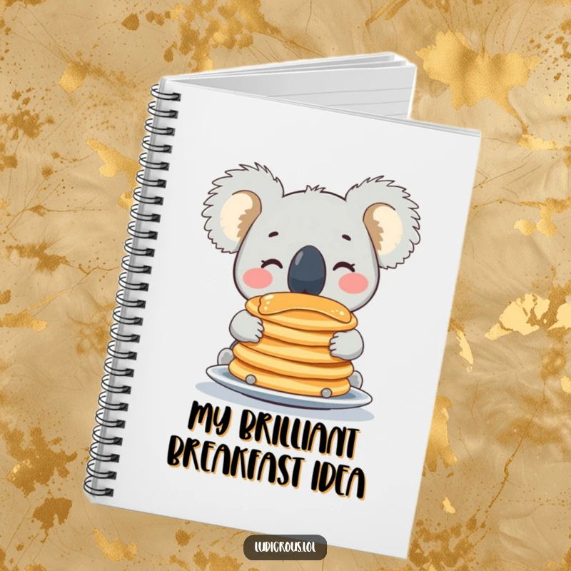 Funny koala notebook with a happy face balancing pancakes on its nose, perfect for jotting down funny thoughts and ideas.