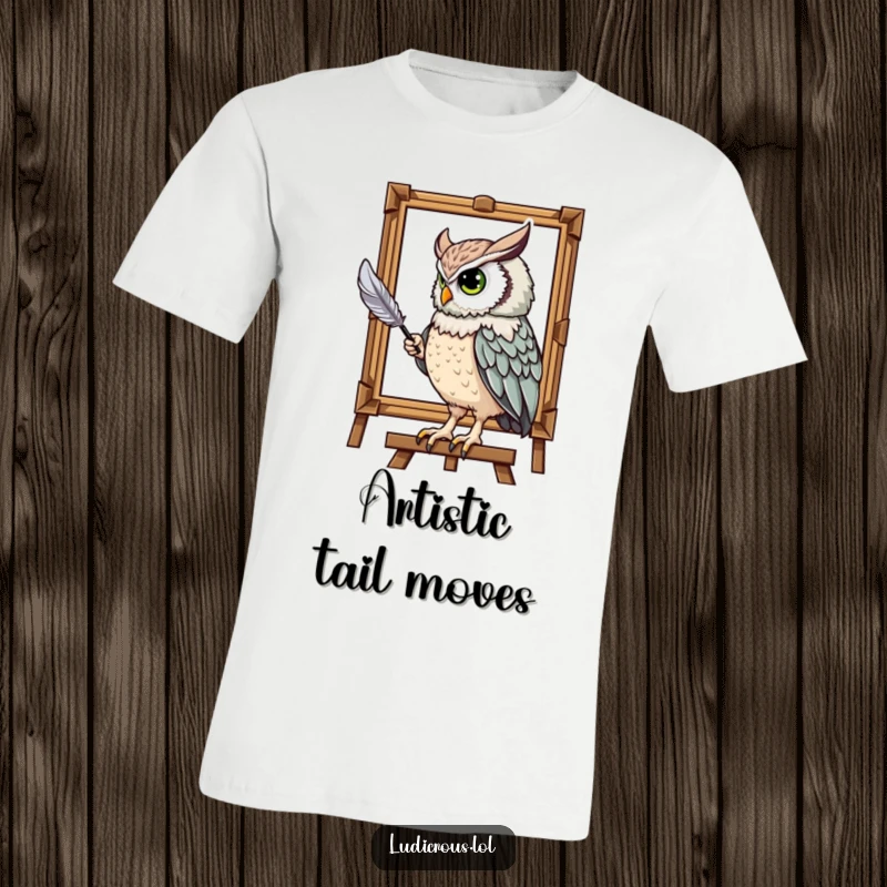 Funny t-shirt showing a majestic owl humorously painting a portrait with its tail feather, perfect for an artistic and funny gift.