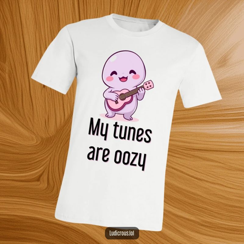 Funny t-shirt graphic of a happy slime creature struggling to play a tiny ukulele, with a look of pure joy.