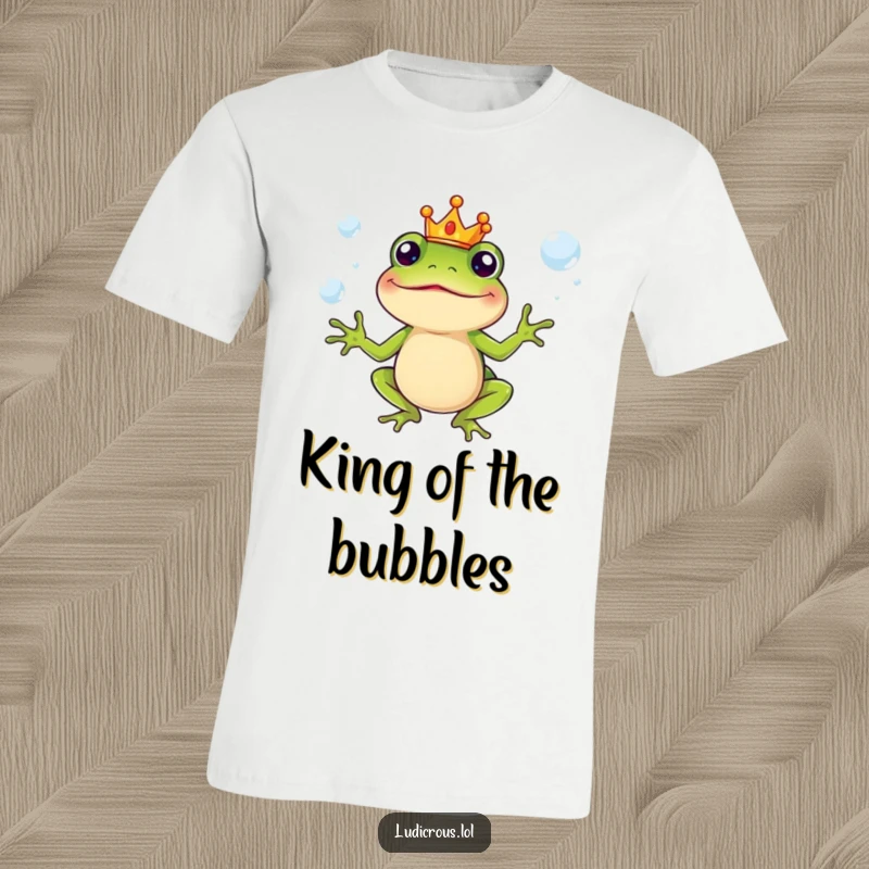 Funny T-Shirt with a silly frog wearing a small crown, juggling slippery soap bubbles, whimsical and humorous apparel.